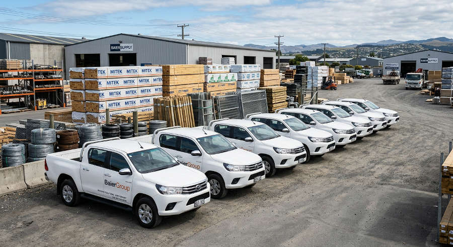 Fleet of white BaierGroup trade utes in the Canterbury yard